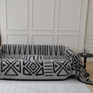 Housse de canapé en peluche à motif géométrique